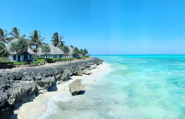 Thatched-roof cottages on the turquoise shores of Zanzibar — an iconic African travel destination