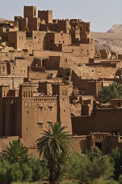 Aït Benhaddou surrounded by desert and palm trees in Morocco