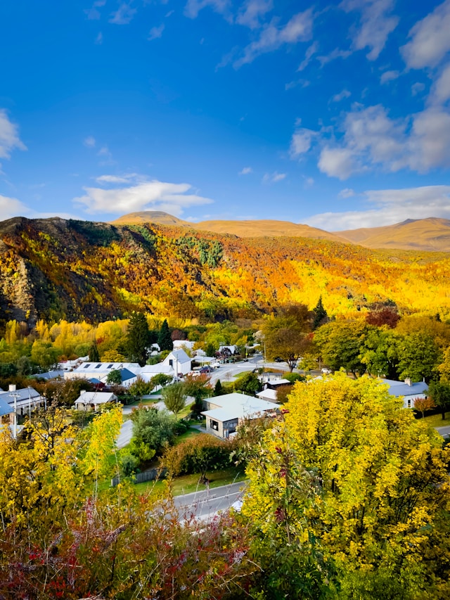 Arrowtown surrounded by vibrant autumn foliage and mountains in New Zealand