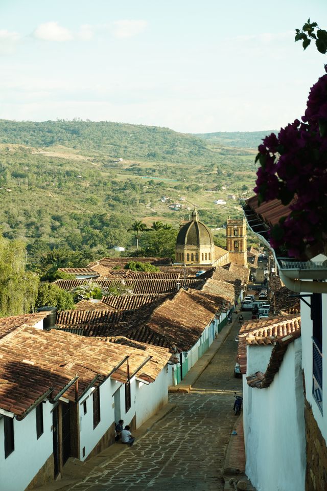 Historic cobblestone street leading to a church in Barichara Colombia