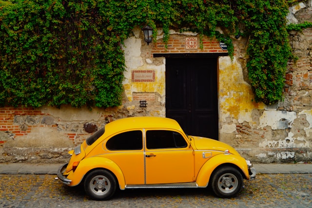 Yellow Volkswagen Beetle on cobblestone streets in Antigua, Guatemala