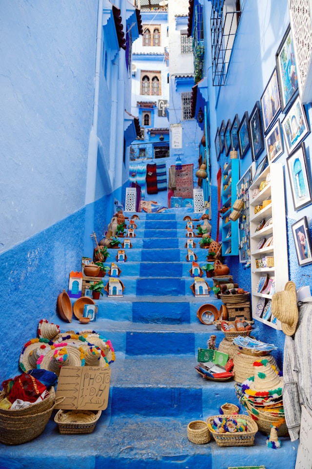 Blue staircase decorated with baskets in Chefchaouen Morocco