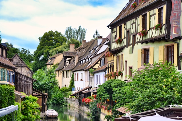 Canal in Colmar, France lined with half-timbered houses and flowers