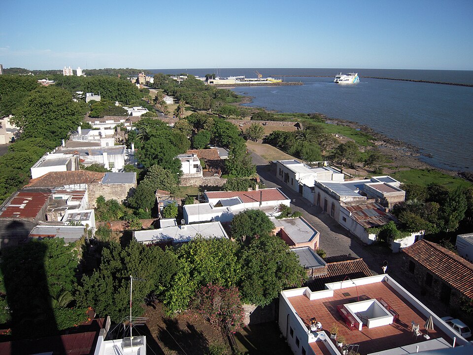 Aerial view from Colonia del Sacramento's lighthouse over the Barrio Histórico rooftops toward the ferry terminal and Río de la Plata