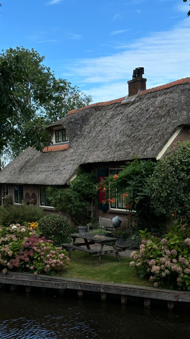 Thatched-roof cottage beside a canal in Giethoorn Netherlands