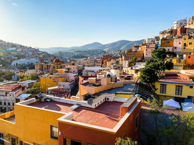 Colorful hillside buildings in Guanajuato Mexico surrounded by mountains