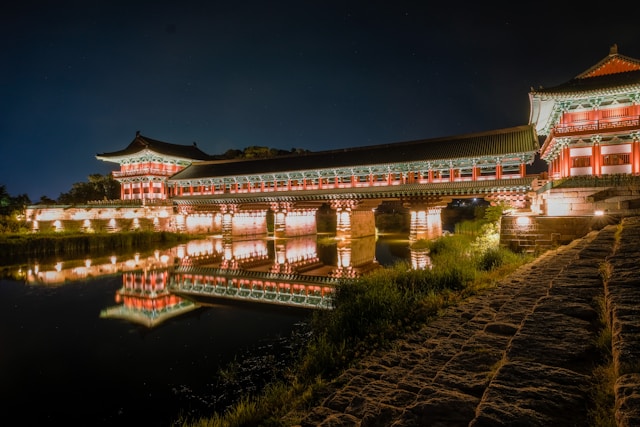 Illuminated pavilion reflected in a pond at night