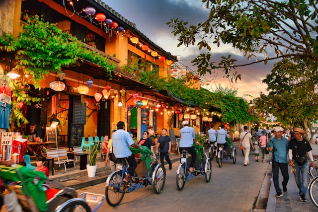 People cycling through the streets of Hoi An Vietnam