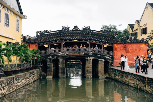 Visitors crossing a bridge in Hoi An Vietnam