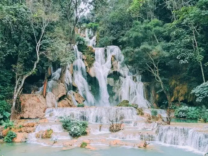 Lower pools of Kuang Si Falls surrounded by tropical forest in Laos