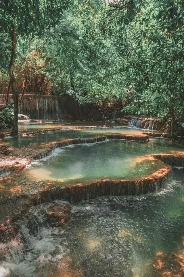 Turquoise forest pools at Kuang Si Falls in Luang Prabang Laos