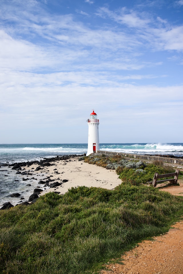 Port Fairy Lighthouse on Griffiths Island viewed from the sandy beach