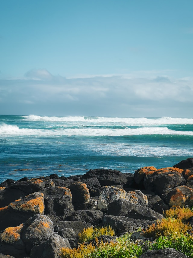 Rocky coastline at Port Fairy with ocean waves crashing against the shore