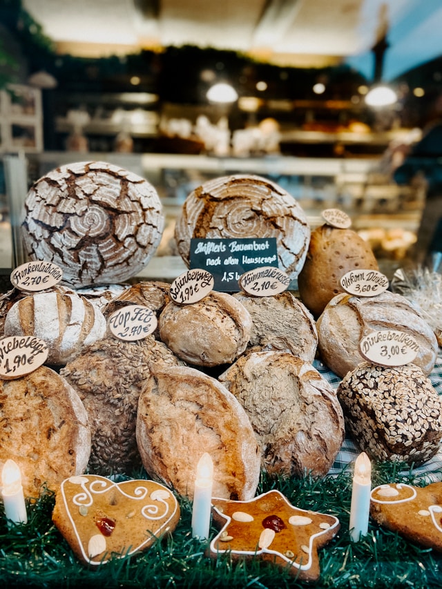 Display of rustic artisan bread loaves and gingerbread cookies at a bakery in Rothenburg ob der Tauber