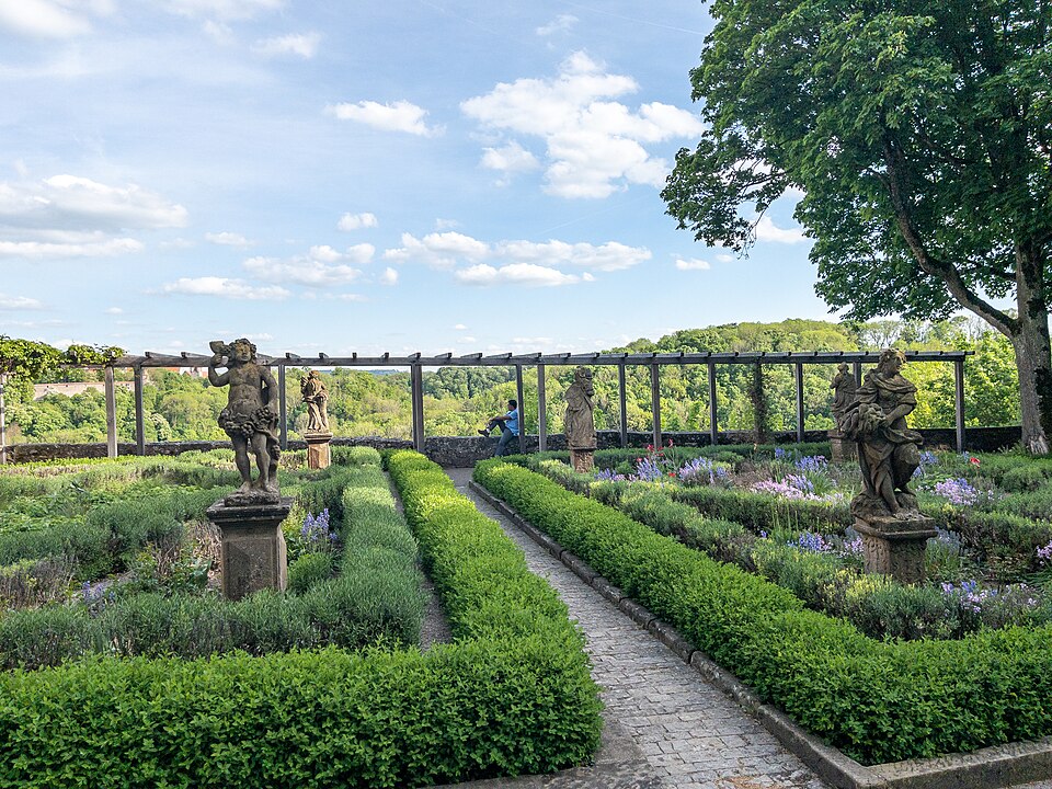 The Burggarten castle garden in Rothenburg ob der Tauber with baroque statues and clipped hedges