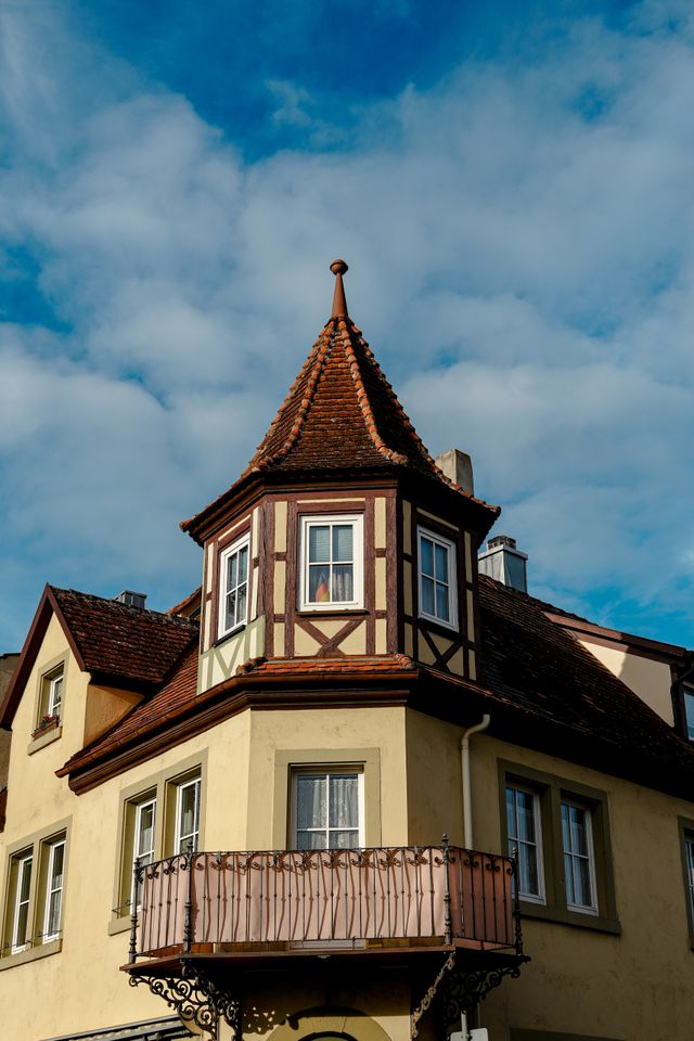 Half-timbered corner oriel turret with a wrought-iron balcony in Rothenburg ob der Tauber