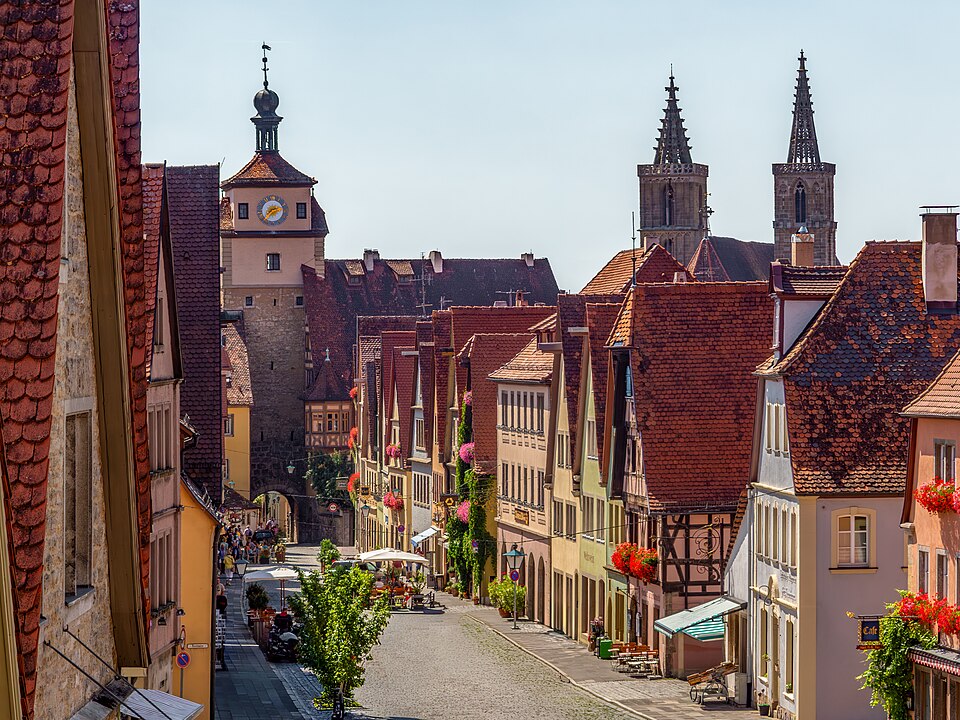 View down Galgengasse in Rothenburg ob der Tauber toward the Weißer Turm and the spires of St. Jakobskirche