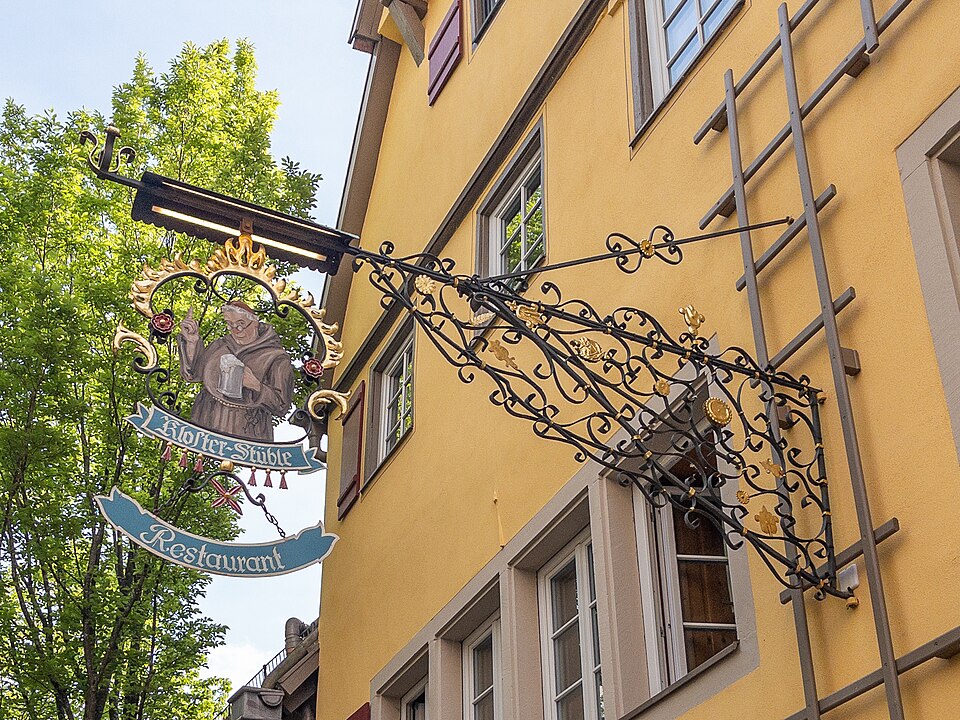 Wrought-iron sign for the Kloster-Stüble restaurant in Rothenburg ob der Tauber