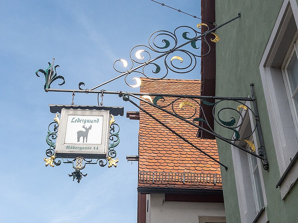Ornate wrought-iron guild sign for Ledergwand on Rödergasse in Rothenburg ob der Tauber