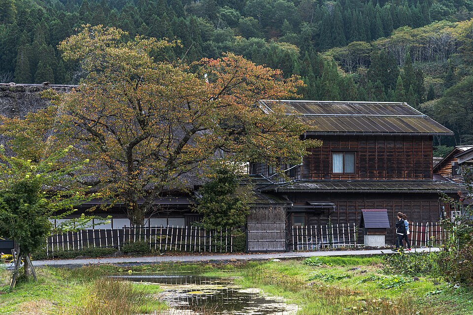 Traditional wooden house beside a pond in Shirakawa-go Japan