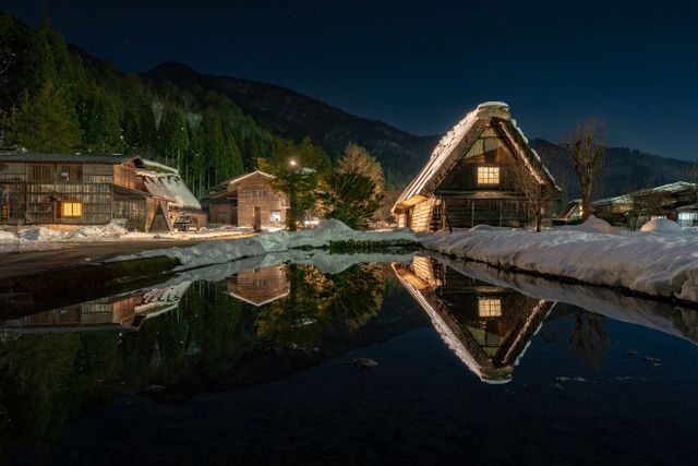 Traditional houses beside a pond in Shirakawa-go Japan during winter