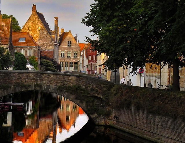 Stone bridge over a canal glowing with sunset light