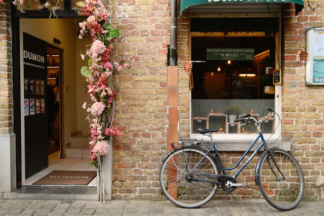 Bicycle parked outside the DUMON Chocolatier shop entrance