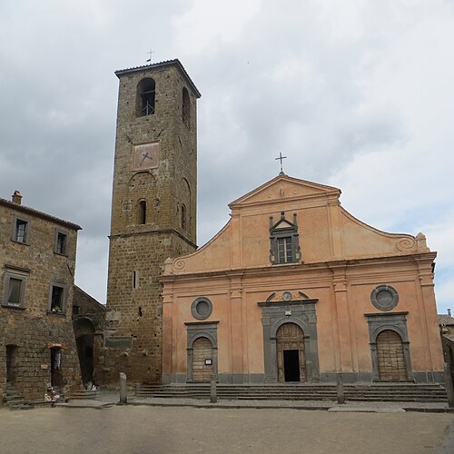 The Church of San Donato and its bell tower under a cloudy sky
