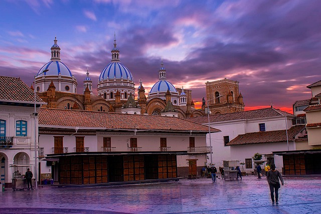 The cathedral's blue domes silhouetted against a pink and purple sunset sky