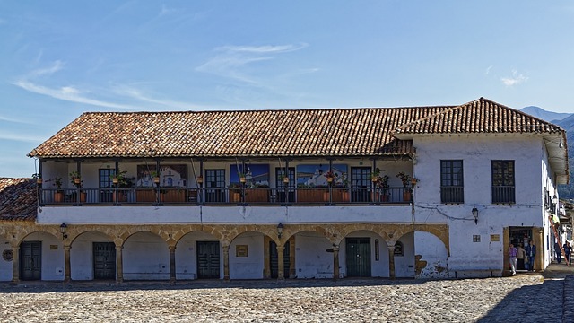 Long colonial building with a covered balcony and terracotta roof