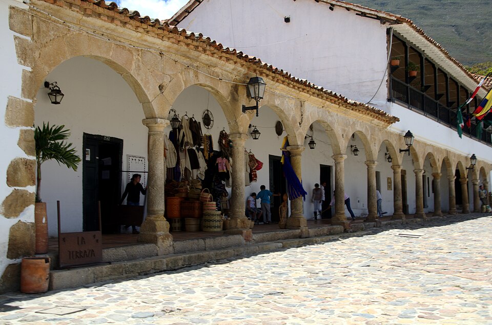 Stone archways of Los Portales sheltering shops on Villa de Leyva's plaza in Villa de Leyva Colombia