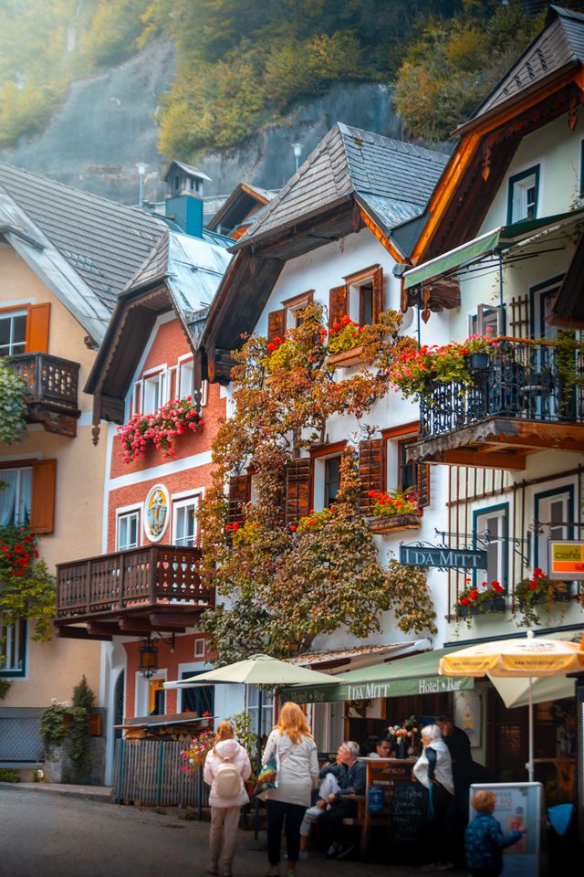 Colorful houses and outdoor cafes along a Hallstatt street