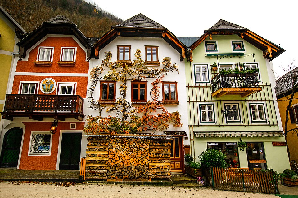 Colorful Marktplatz houses in Hallstatt with an autumn tree growing up the wall