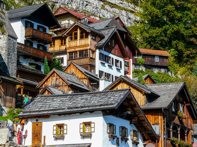 Houses stacked on Hallstatt's steep hillside beneath rocky mountain cliffs