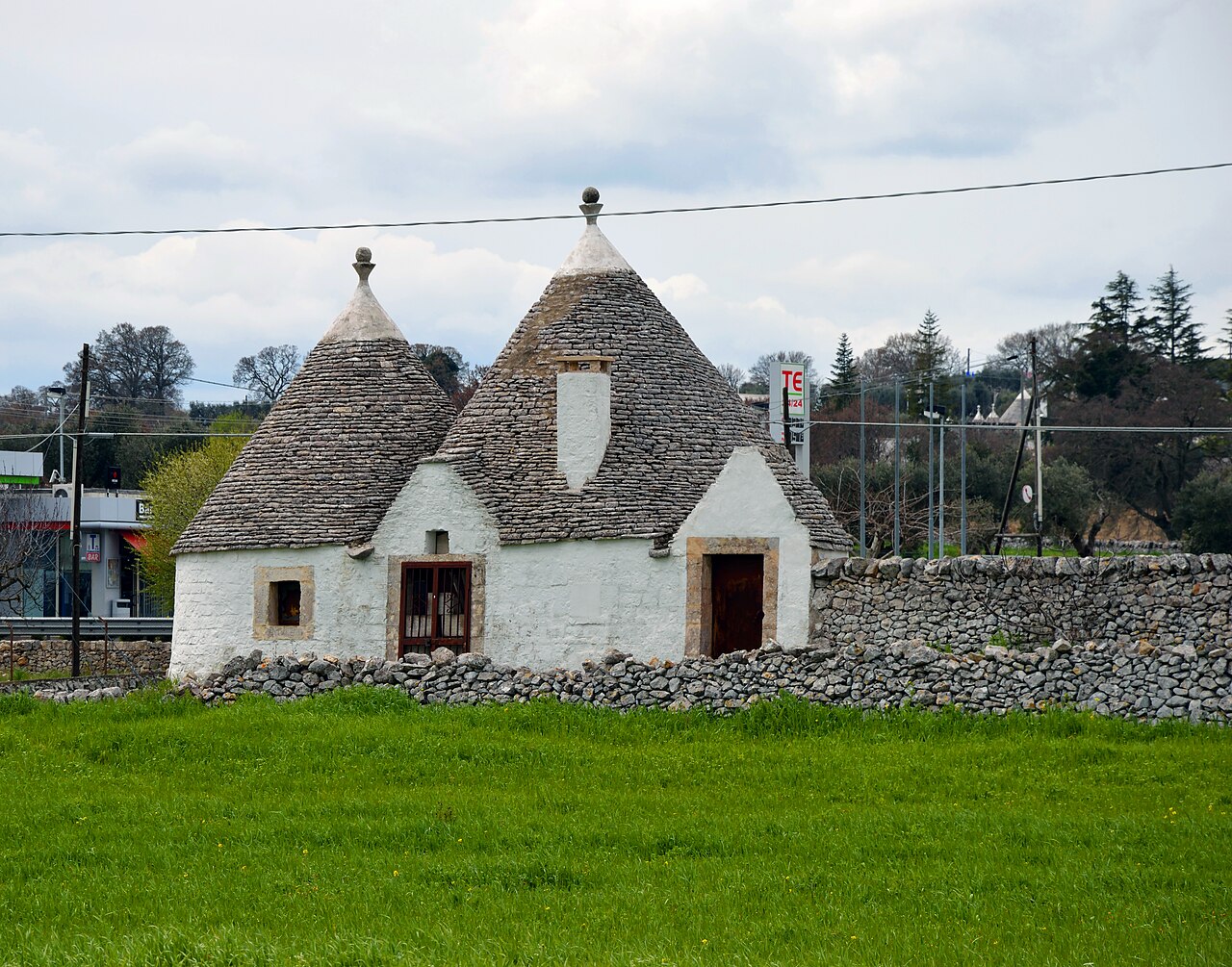 Whitewashed trulli with cone-shaped stone roofs in Alberobello Italy