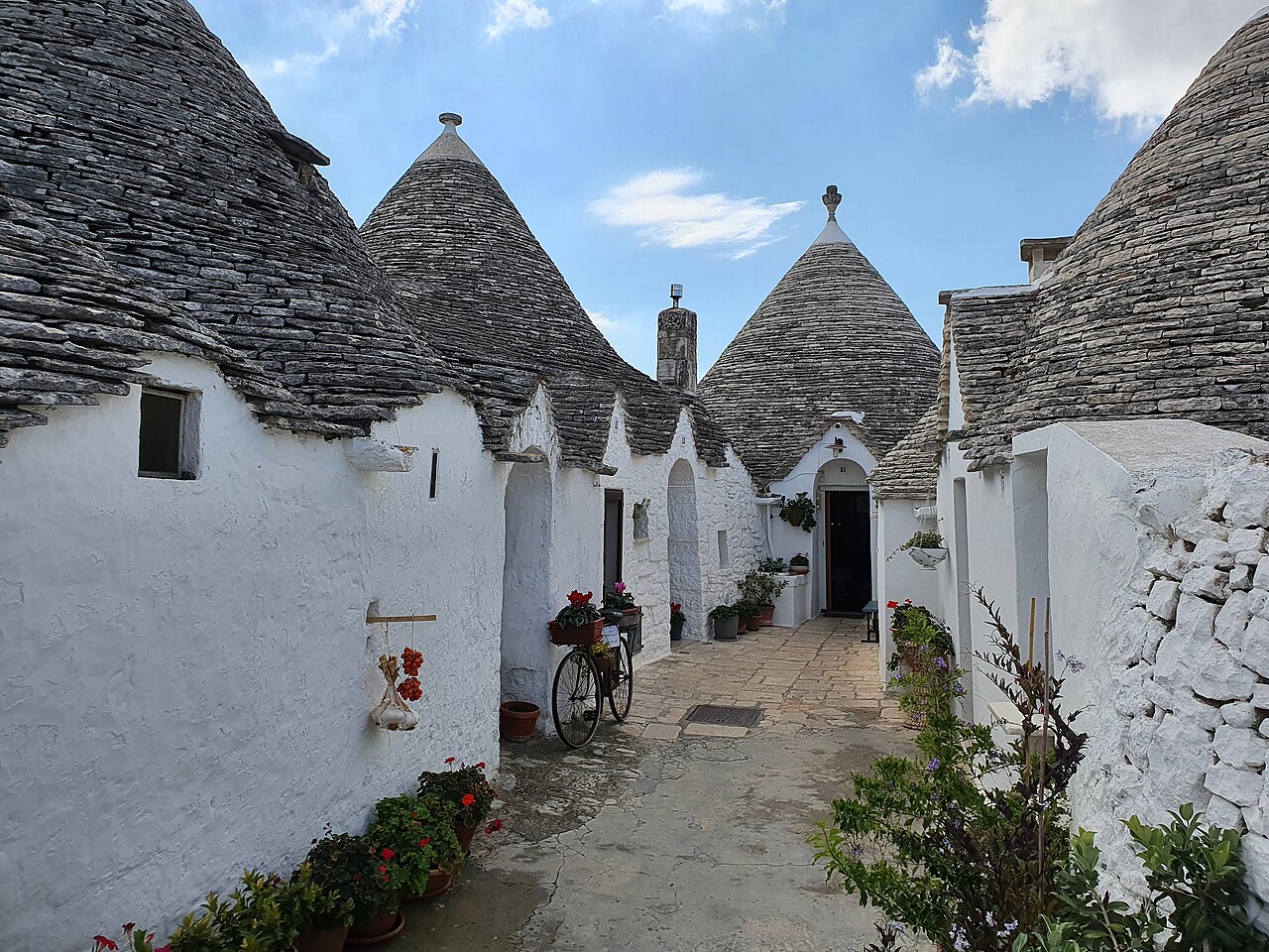 Narrow street lined with trulli houses in Alberobello Italy
