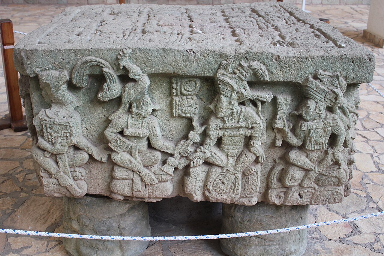 Carved stone altar showing seated Maya rulers