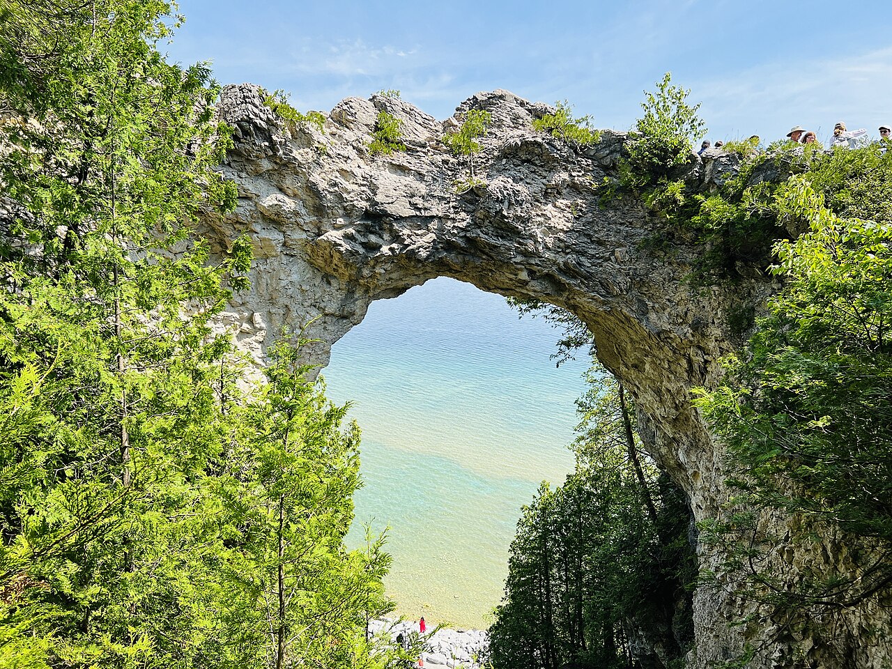 Natural limestone arch above blue water