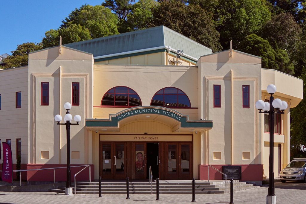 An Art Deco building with arched windows and a decorative parapet