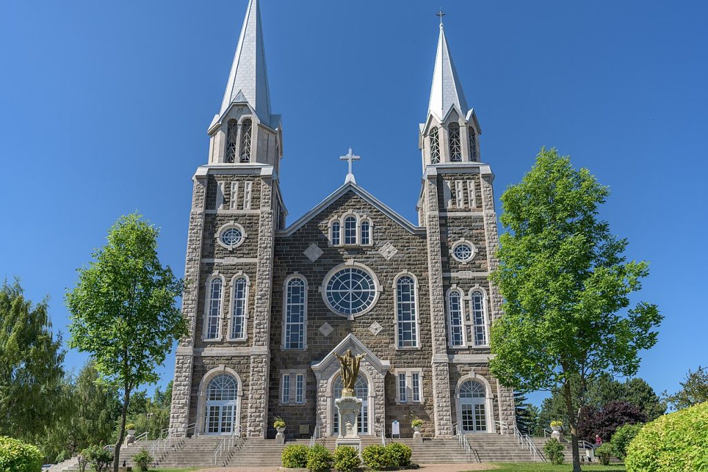The stone facade and twin towers of the Baie-Saint-Paul parish church