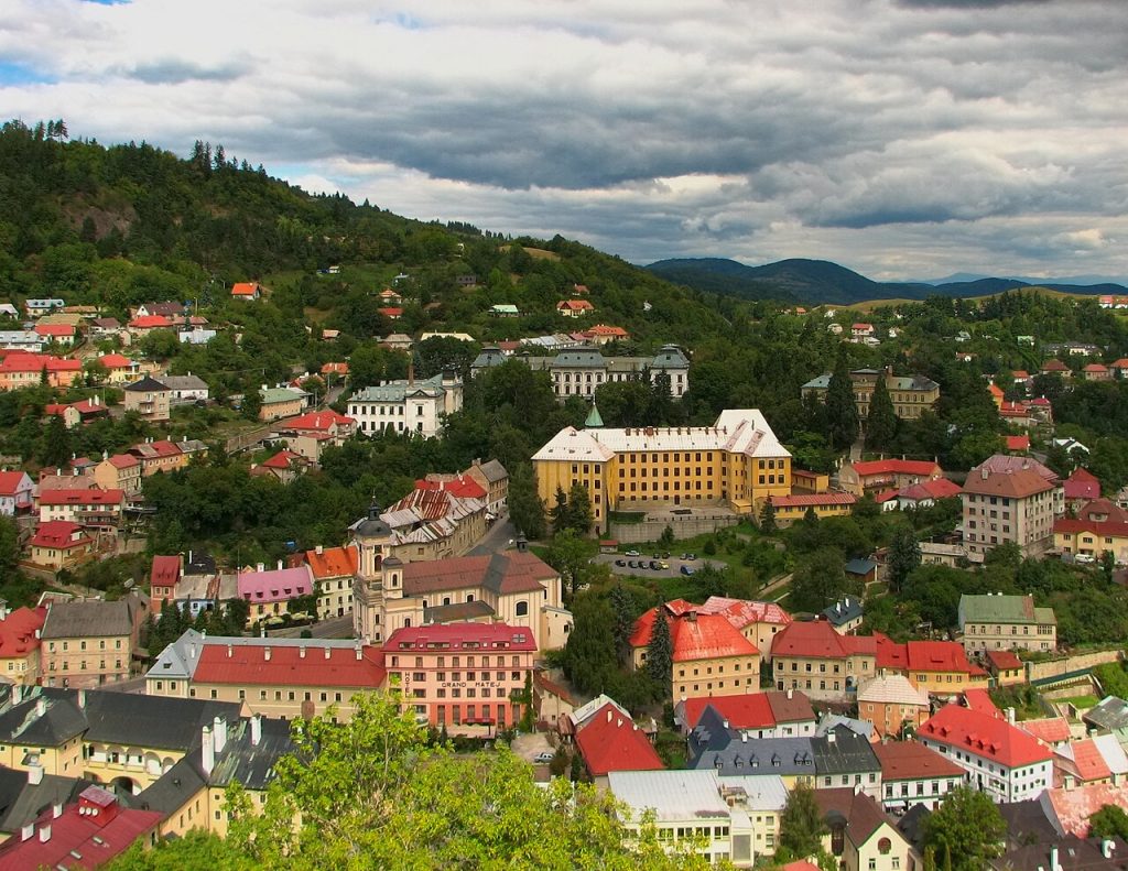 Banská Štiavnica Slovakia red roofs spread across green hills, seen from the New Castle