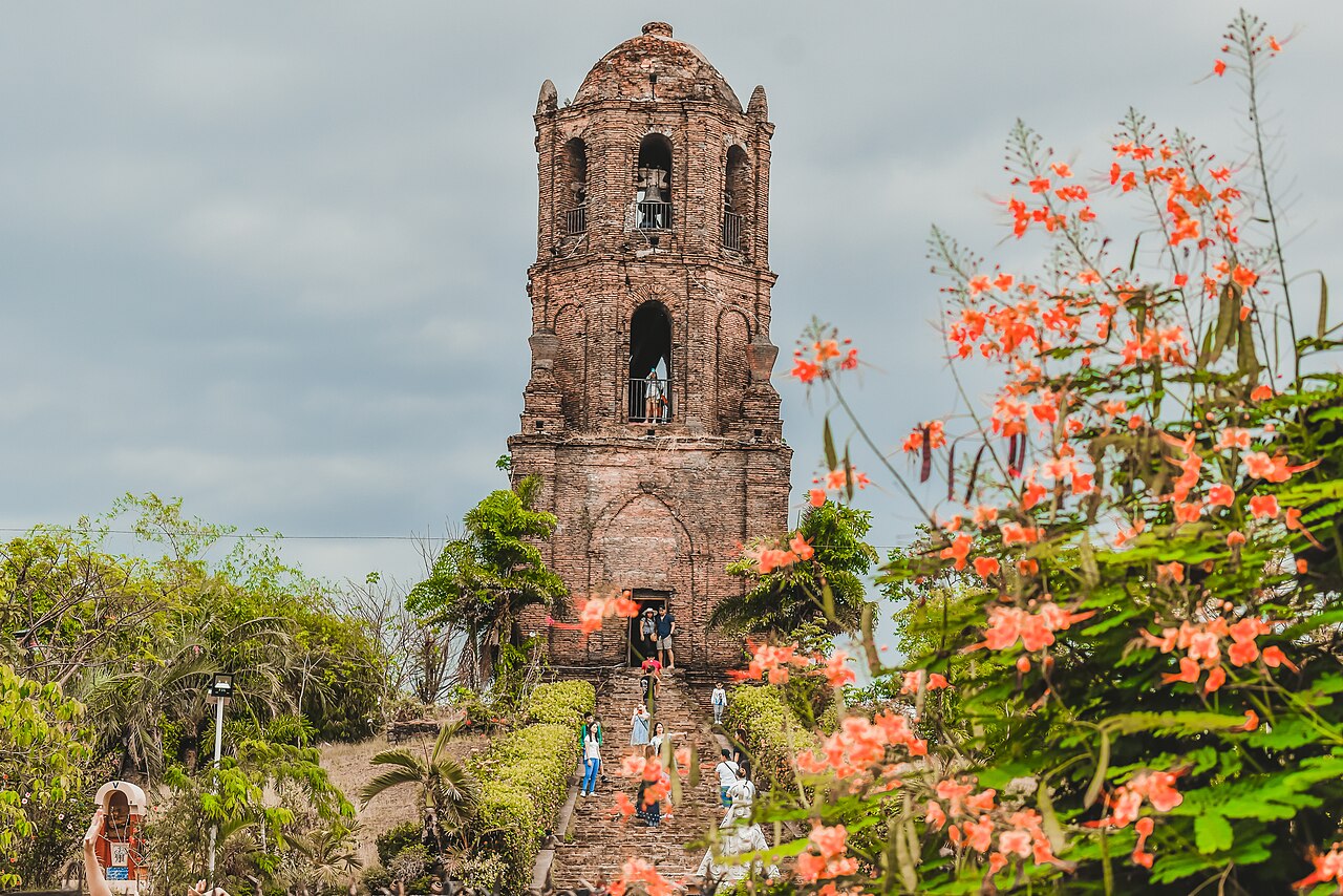 Old brick Bantay bell tower on a grassy hill