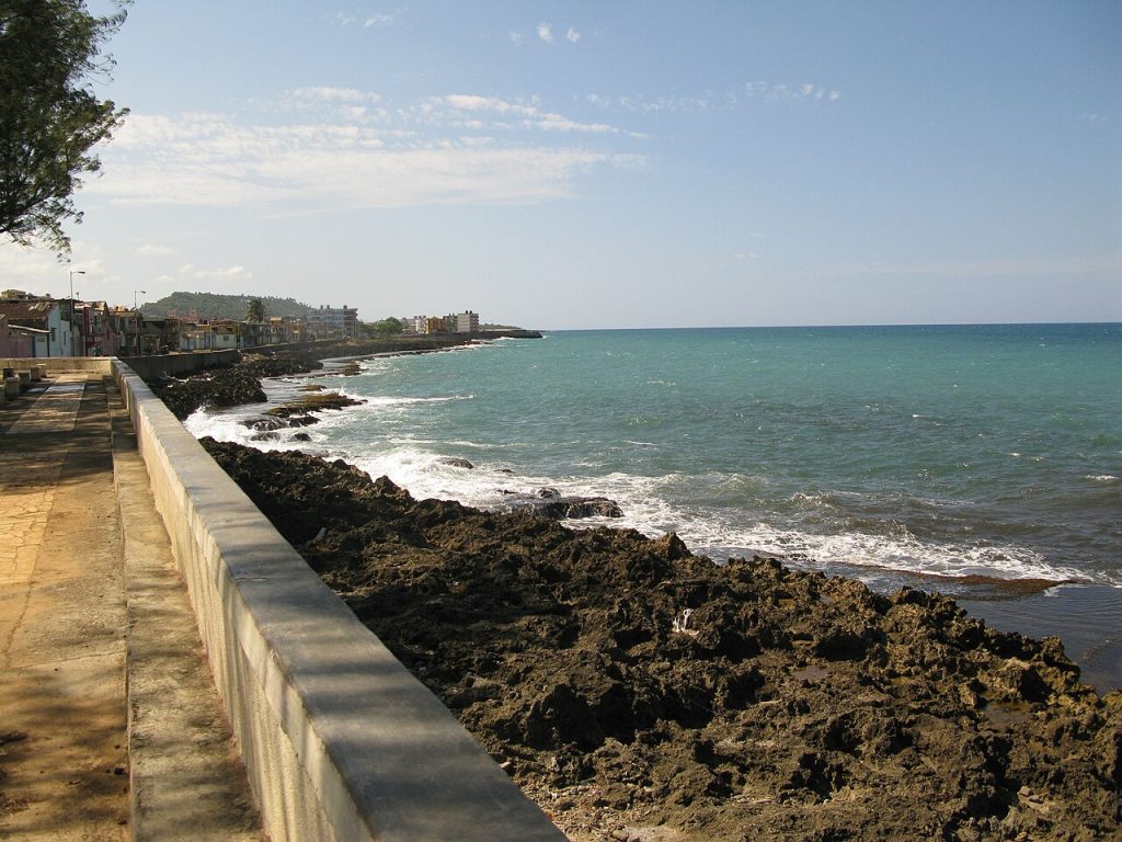 The seafront promenade and sea wall beside the turquoise sea