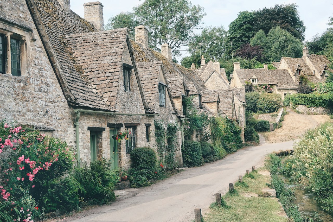 Stone cottages surrounded by trees in Bibury England