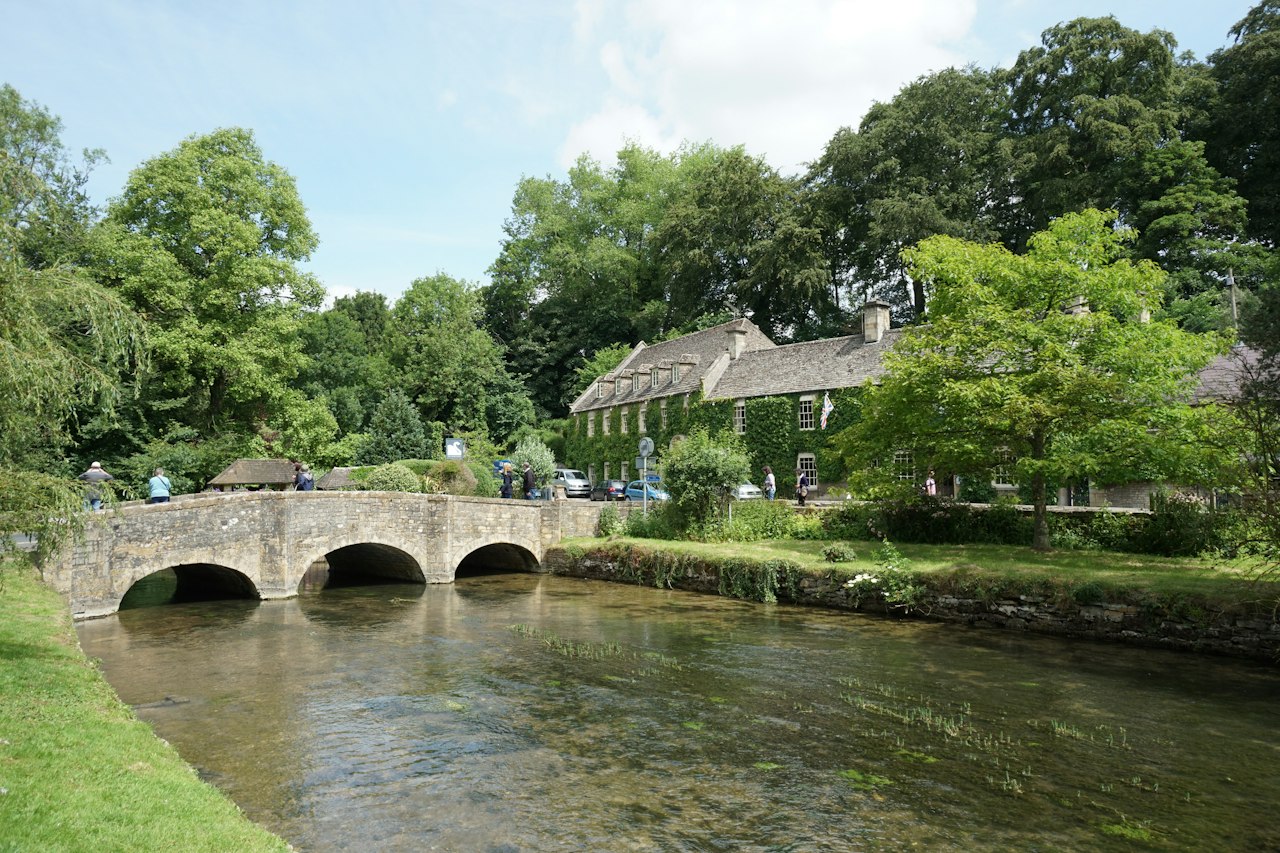 Small stone footbridge between grassy banks