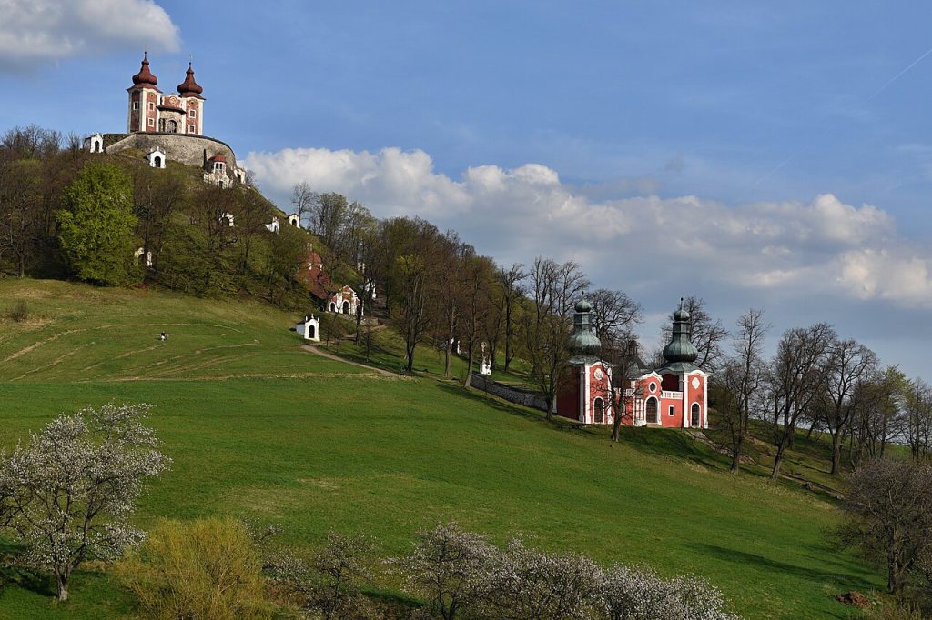 Small chapels of the Calvary climbing a green hillside