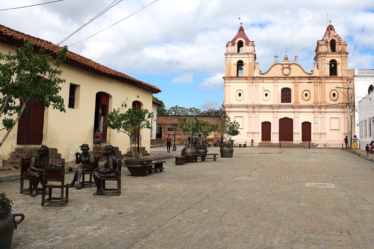 Church with two towers beside a cobbled plaza