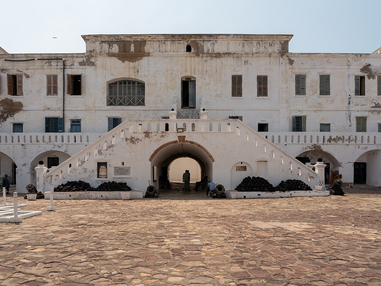 White walls and cannons of Cape Coast Castle by the sea in Cape Coast Ghana