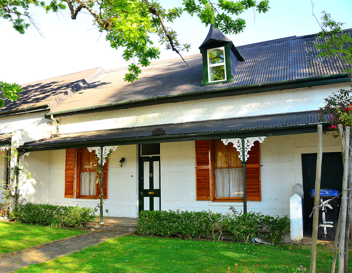 White gabled Cape Dutch house with a thatched roof on Dorp Street