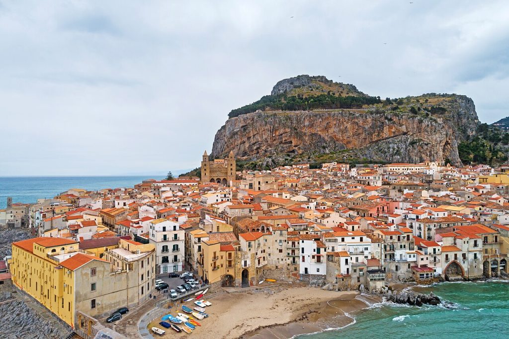 Cefalù Sicily rooftops beneath the great rock of La Rocca